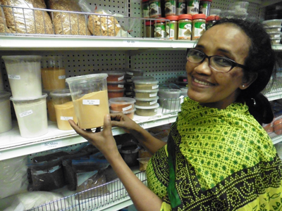 Tsige Meshesha shows off spices and other ingredients for sale at Nile Grocery.