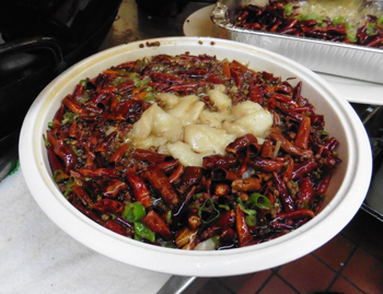 Szechuan Spicy Fish Filet bowl brims with red peppers.
